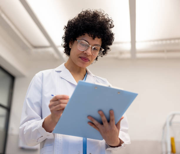 istock Doctor writing on a clipboard at a clinic 2159759659