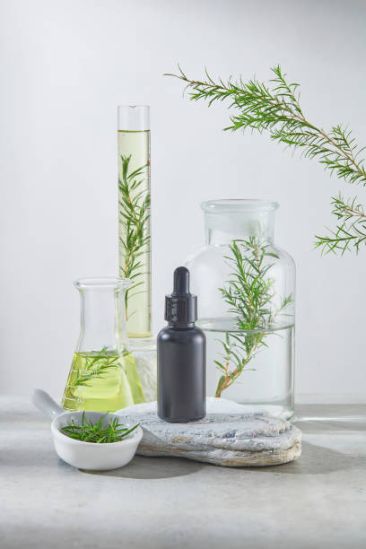 istock A black serum bottle without label displayed on a stone podium and featured on some lab utensils in back, tea tree contained in glassware and decorated on both sides. Blank space for adding text 2159760295