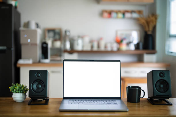 Open laptop with blank screen on a wooden desk in a kitchen room home office