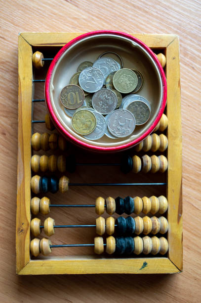 istock Russian currency, coins lie next to hand abacus on a wooden surface 2159762438
