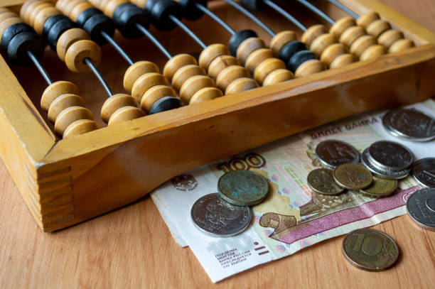 istock Russian currency, coins, banknotes and hand abacus lie on the surface 2159763029