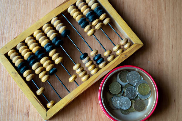 istock Russian currency, coins lie next to hand abacus on a wooden surface 2159763174