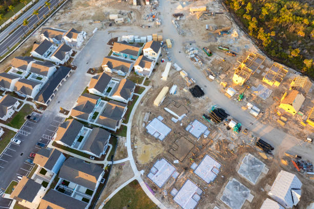 Aerial view of unfinished wooden frames of affordable houses under construction. Development of residential housing in American suburbs. Real estate market in the USA Aerial view of unfinished wooden frames of affordable houses under construction. Development of residential housing in American suburbs. Real estate market in the USA. famous american landmark drawing stock pictures, royalty-free photos & images