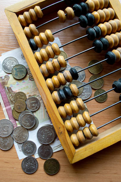istock Russian currency, coins, banknotes and hand abacus lie on the surface 2159763488