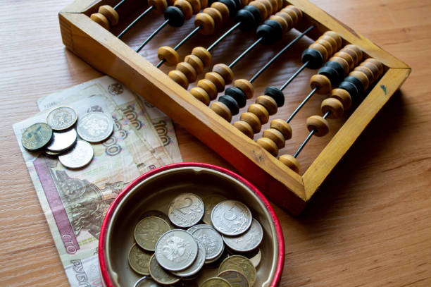 istock Russian currency, coins, banknotes and hand abacus lie on the surface 2159763813
