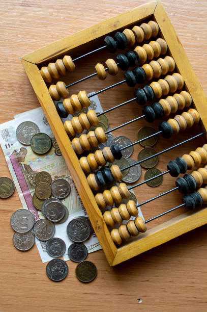istock Russian currency, coins, banknotes and hand abacus lie on the surface 2159763971