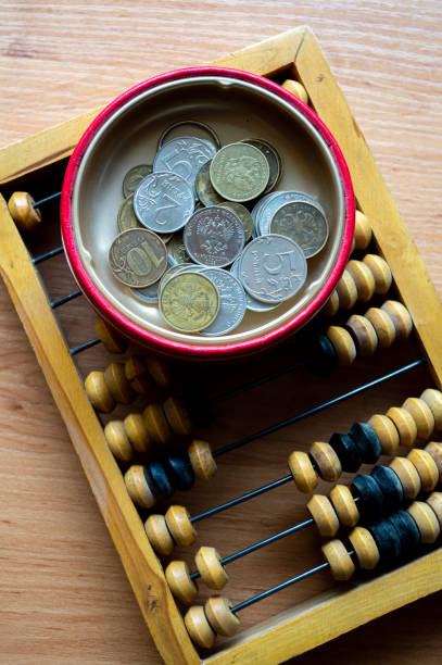 istock Russian currency, coins lie next to hand abacus on a wooden surface 2159764086