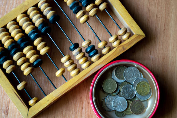 istock Russian currency, coins lie next to hand abacus on a wooden surface 2159764313