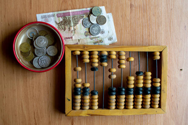 istock Russian currency, coins, banknotes and hand abacus lie on the surface 2159764397