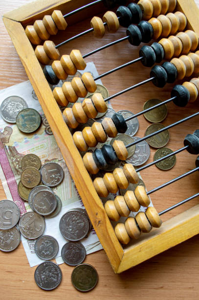 Russian currency, coins, banknotes and hand abacus lie on the surface