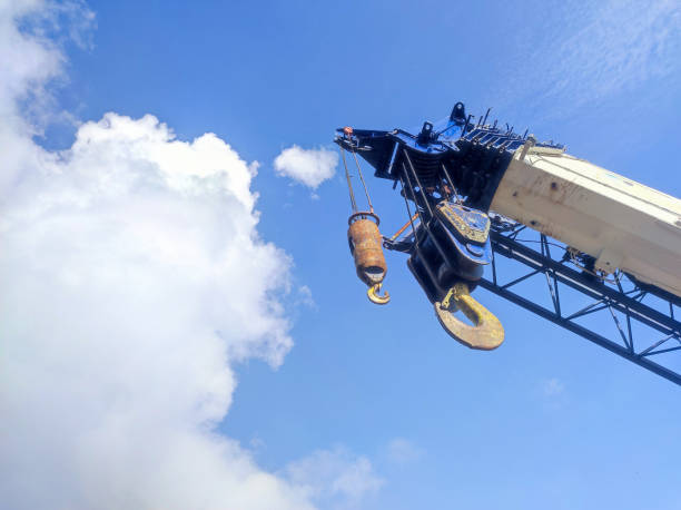 istock crane boom and hook ready for lifting against bright blue sky background 2159764475
