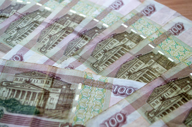 istock Russian currency, banknotes lie on a wooden surface 2159764686