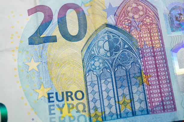 Eurozone currency, coins, banknotes remain on a wooden surface. High quality photo
