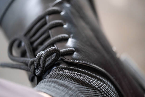 Close-Up Of Elegant Brown Leather Oxford Shoes With Decorative Brogue Detailing, Placed On A Clean White Background. The Polished Surface And Classic Design Highlight Timeless Men’s Fashion, Formal Wear, And Traditional Craftsmanship.
