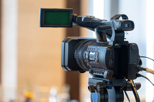 istock Professional video camera on tripod with green screen display 2159765928