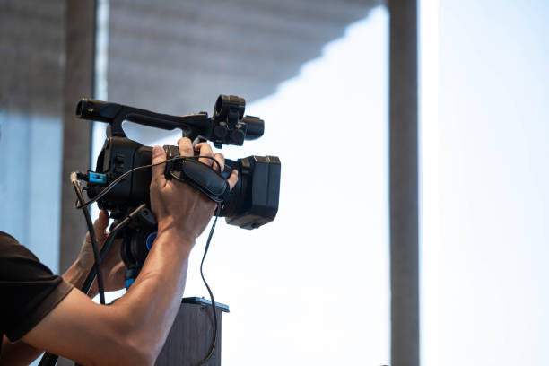 istock Person operating professional video camera indoors 2159765934