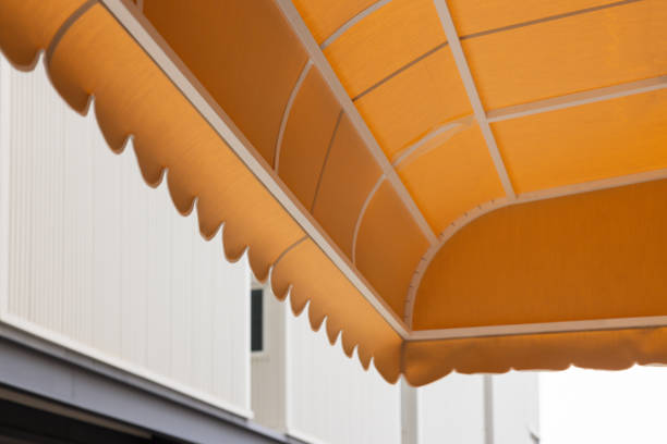 istock A large orange awning with white trim is above a building 2159771824
