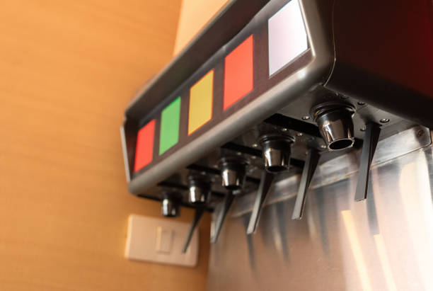 A machine beverage dispensers with a red sign on the wall.