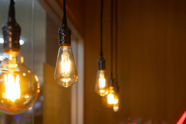 istock A row of light bulbs hanging from the ceiling, with one bulb being the brightest 2159771964