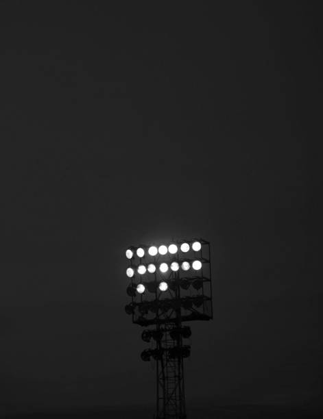 istock illuminated stadium lights during a black and white night event 2159773453