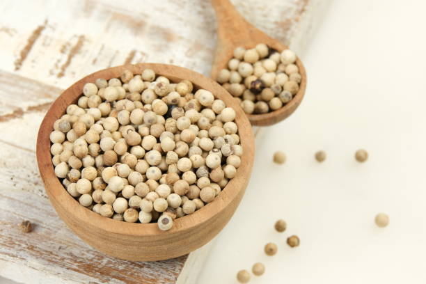 istock White pepper or peppercorns in wooden spoon with bowl 2159774748