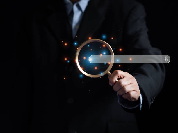 istock (SEO) Search engine optimization. Businessman use magnifier glass focus icon search engine bar on interface virtual screen. Searching browsing Internet data information. 2159777638
