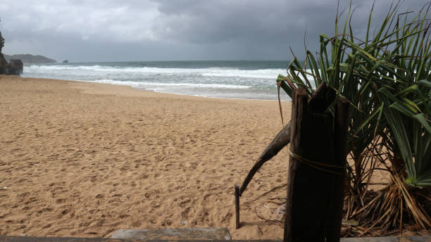 istock Beachside atmosphere with a view of waves and cloudy skies 2159779601