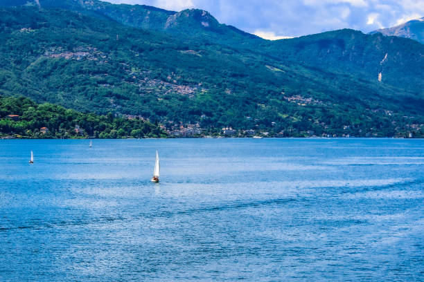 Sailboats in the blue water of Lake Maggiore, Varese, Lombardy, Italy
