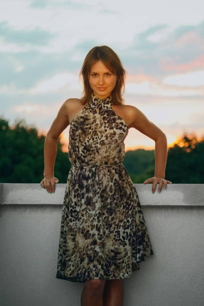 istock Cheerful woman on balcony at sunset 2159783351
