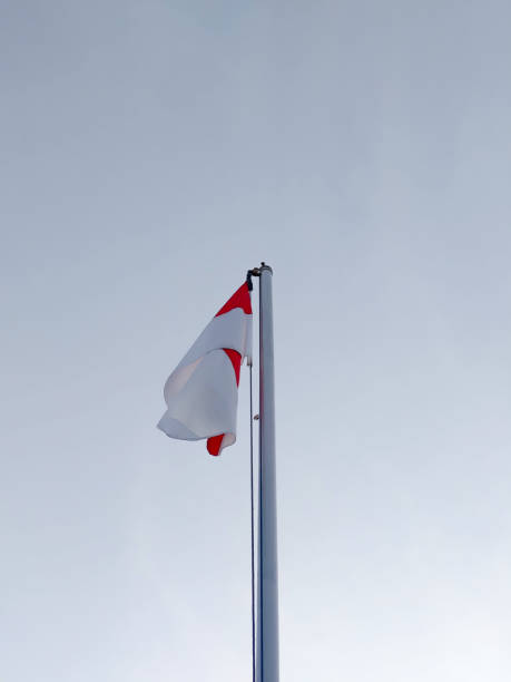 istock Indonesian flag on a pole with a sky blue background 2159784047