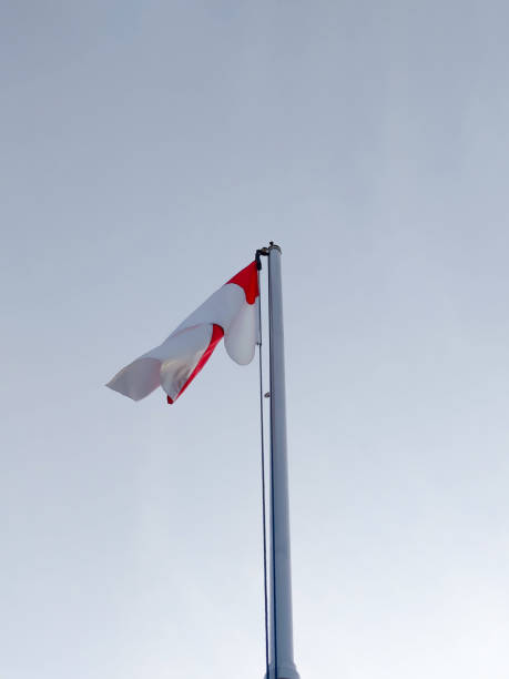 istock Indonesian flag on a pole with a sky blue background 2159784107