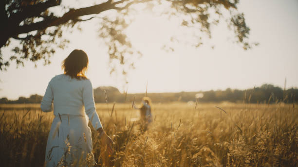 istock Joyful Sunset Swinging with Mother and Daughter 2159788818