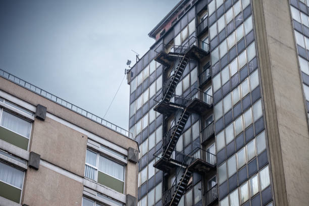 Emergency stairs on an old skyscraper building in North America depict urban architecture and safety design. This image highlights the functional aspect of emergency exits in high-rise buildings, reflecting the structural and safety considerations in urban planning. The weathered exterior of the building adds a sense of history and character, illustrating the architectural style and urban landscape of North American cities.