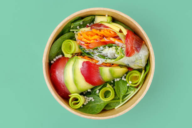 istock rolls in rice paper with salmon on a green background 1 2159793889