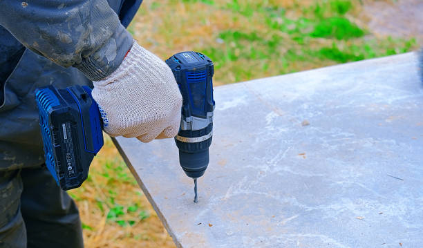 istock A worker's hands drill plywood with a battery-powered electric drill, close-up 2159796815