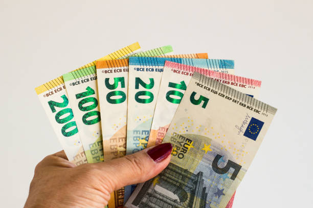 istock A hand with red nail polish holding Euro Banknotes 2159796852