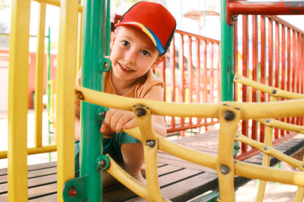 Little boy climbs up the ladder on the playground