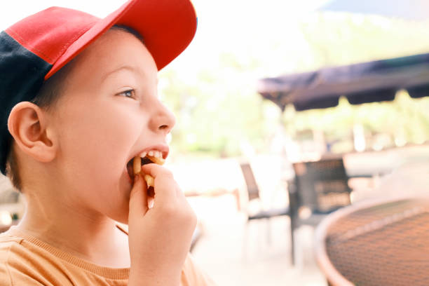 Young boy having a French fry