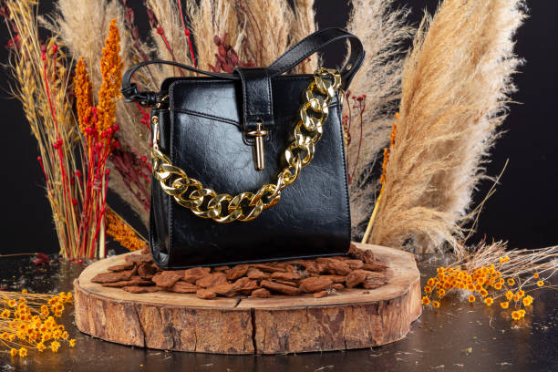 Vintage Black Leather Quilted Shoulder Purse Hanging on a Cream-Colored Hutch