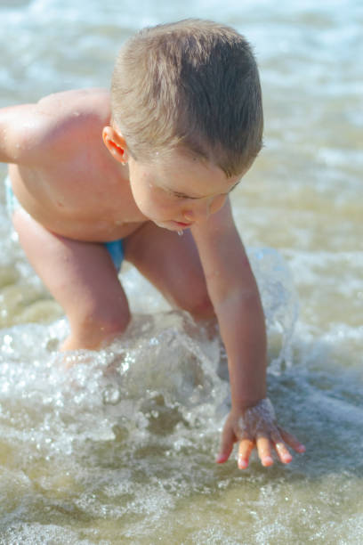Boy is playing at the beach stock photo