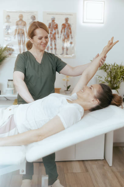 istock smiling female therapist in massage cabinet doing checkup 2159803671