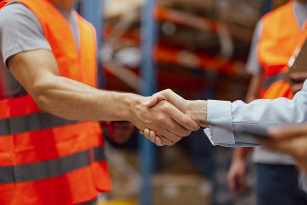 istock Warehouse manager hiring an employee and handshaking his hand 2159805974