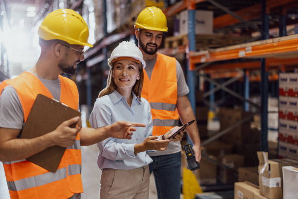 istock Female foreperson Making Plans with Warehousemen 2159806116