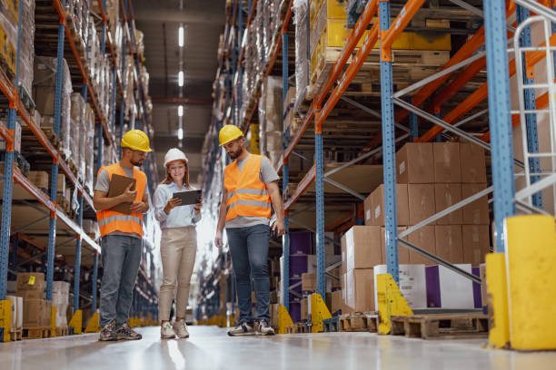 istock Female foreperson Making Plans with Warehousemen 2159806121
