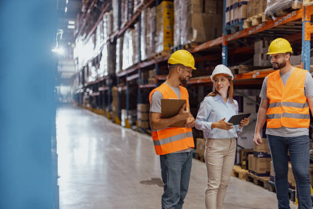 istock Female foreperson Making Plans with Warehousemen 2159806148