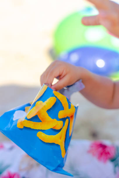Baby boy eating snacks stock photo