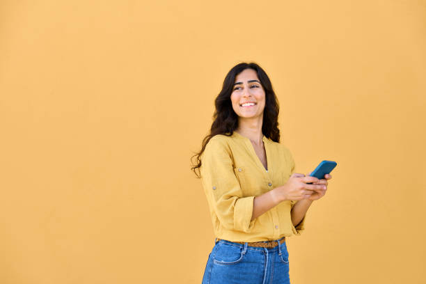 istock Young middle eastern brunette woman in casual clothes using mobile cellphone app for communication, shopping, buying, trade online. Smiling arabian girl holding smartphone phone, looking at copy space 2159806270
