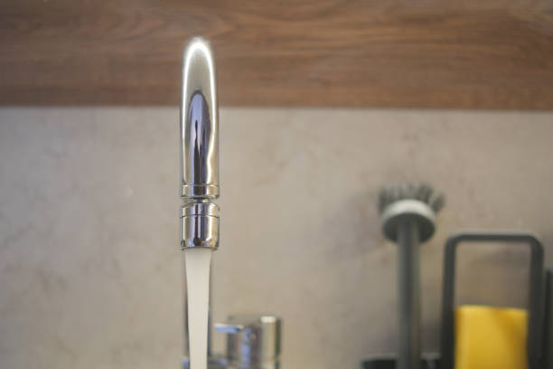 water pouring from a faucet tap slow motion .