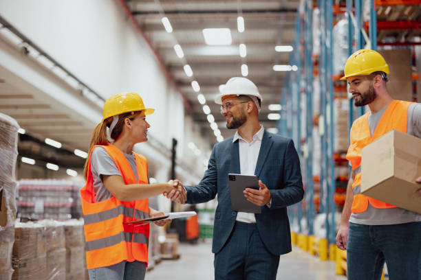 istock Good job! Female warehouse worker and manager shaking hands in warehouse 2159807357