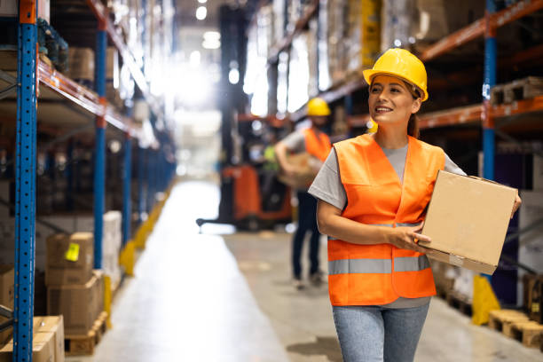 istock Female warehouse worker carries box 2159807844